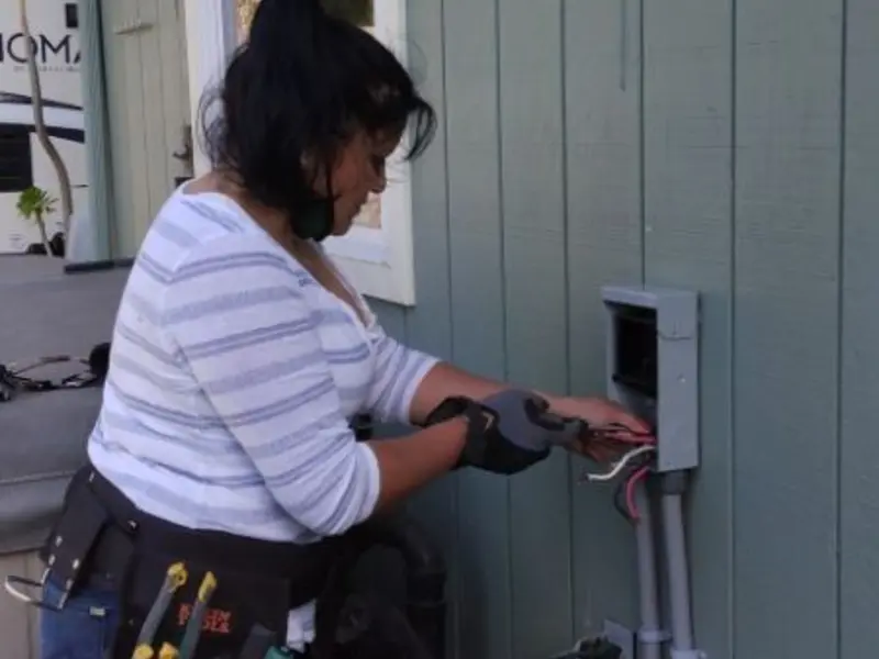 Licensed electrician wiring an exterior subpanel in Jupiter Farms